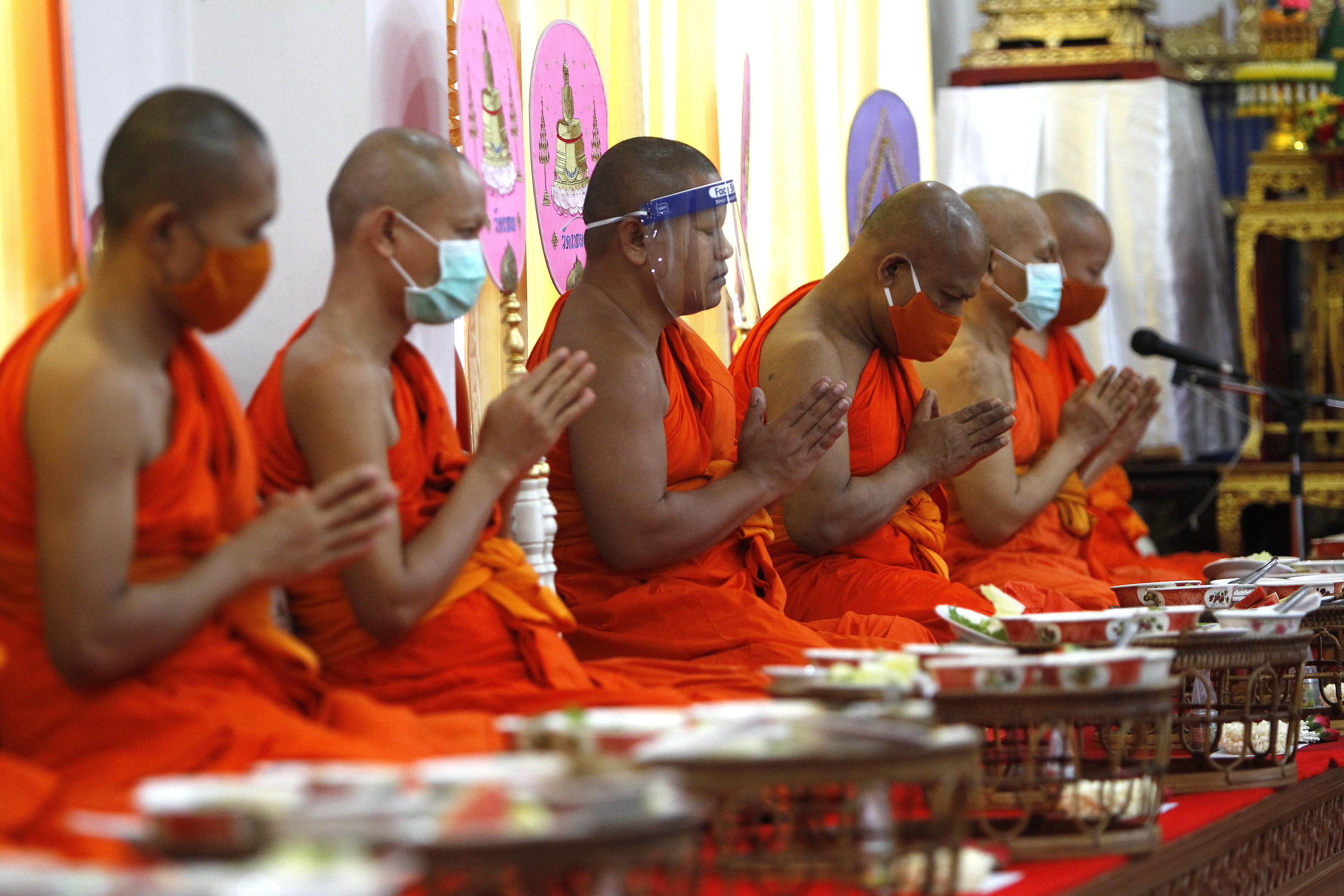 Masked prayer at a Buddhist temple in Thailand