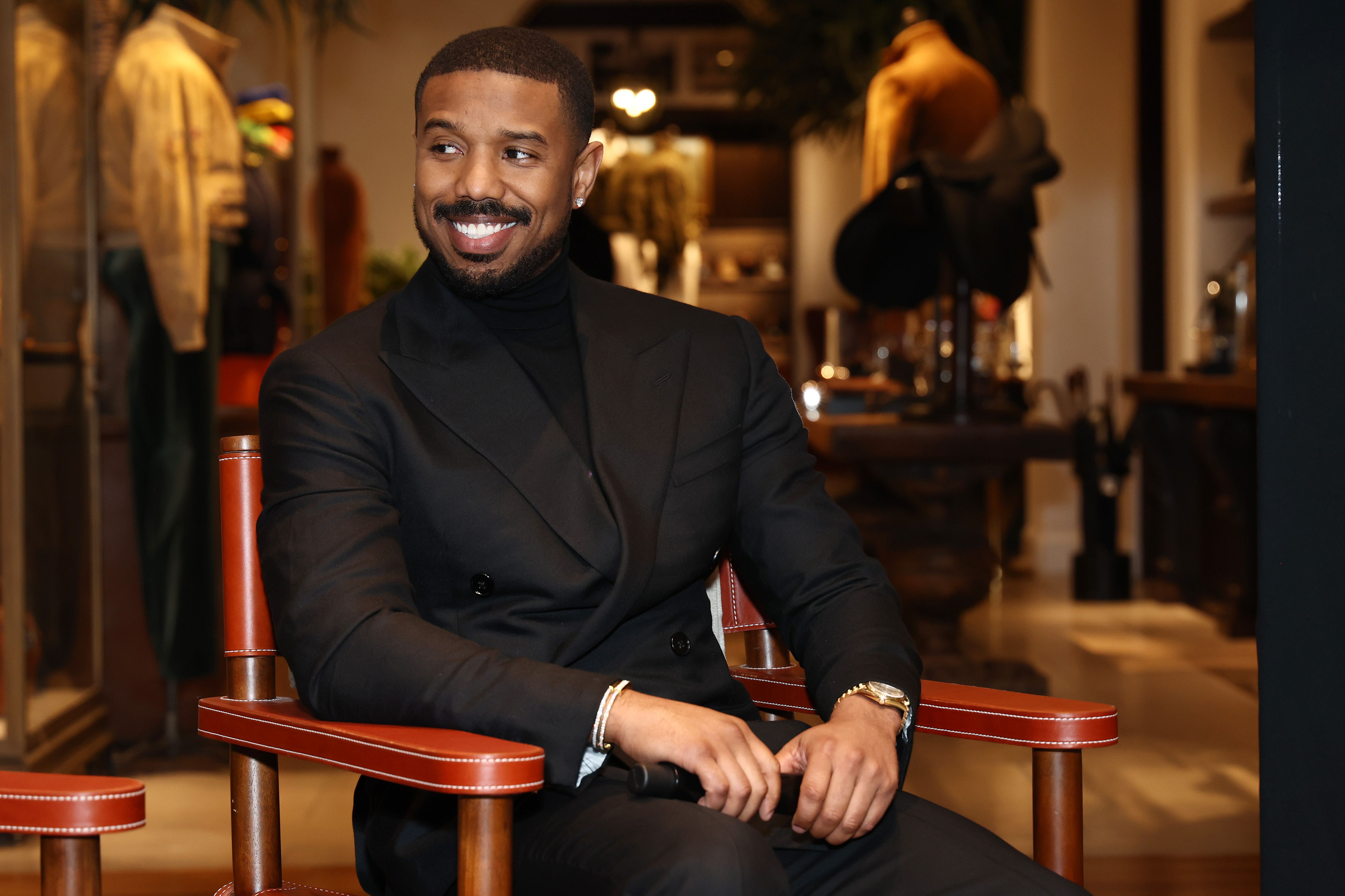 Michael B. Jordan in a black suit.
