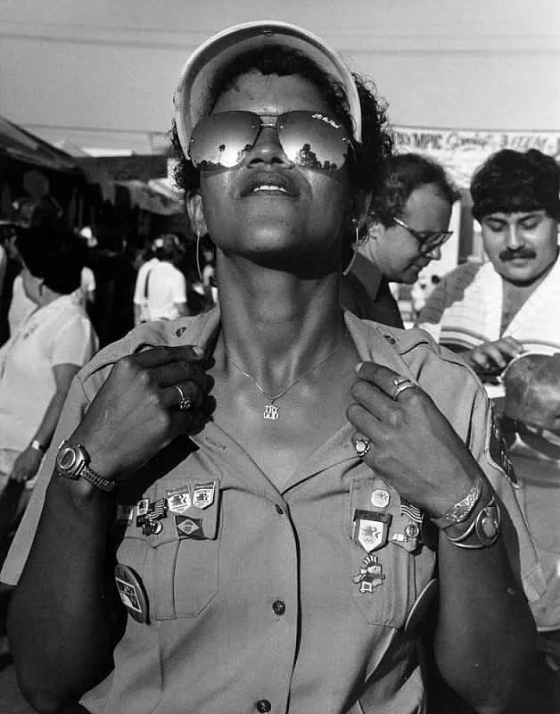 A guard from 1984 with a shirt and aviator glasses.