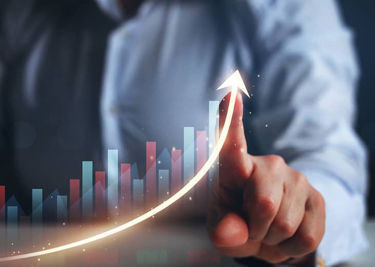 Businessperson finger pointing arrow graph.