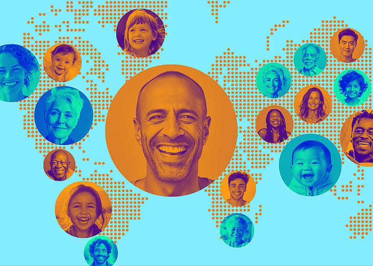 Diverse range of smiling faces laid over a dotted world map.