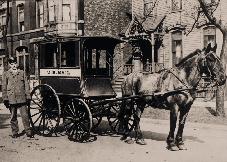 Postman delivers mail by horsedrawn carriage