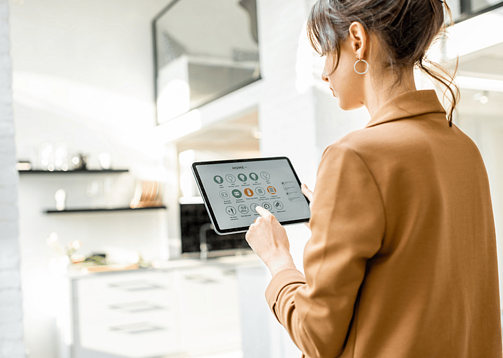 Woman with tablet managing smart home devices
