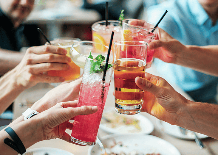 Friends toasting with drinks.
