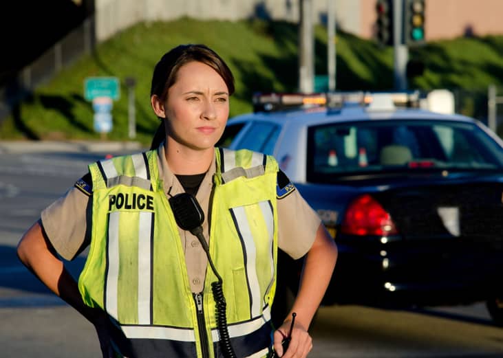 Woman police officer surveys area during a shift.