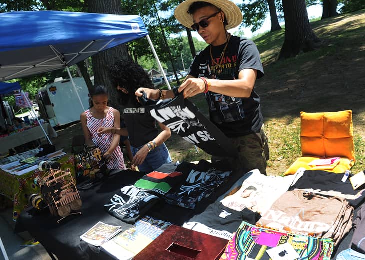 A woman fundraises for a community center at a Juneteenth celebration in Schenectady.