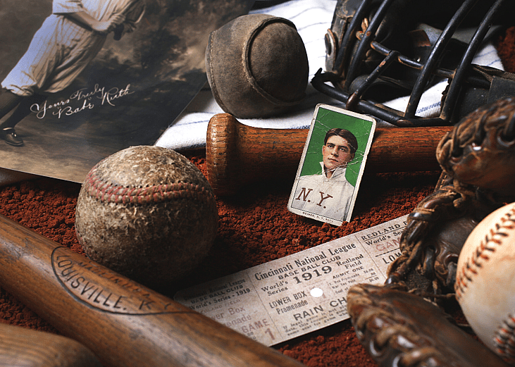 A collection of vintage baseball memorabilia including a baseball card of Babe Ruth