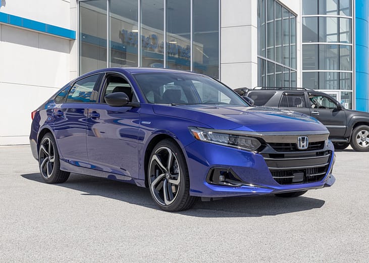 A blue Honda Accord sits in a car dealership.