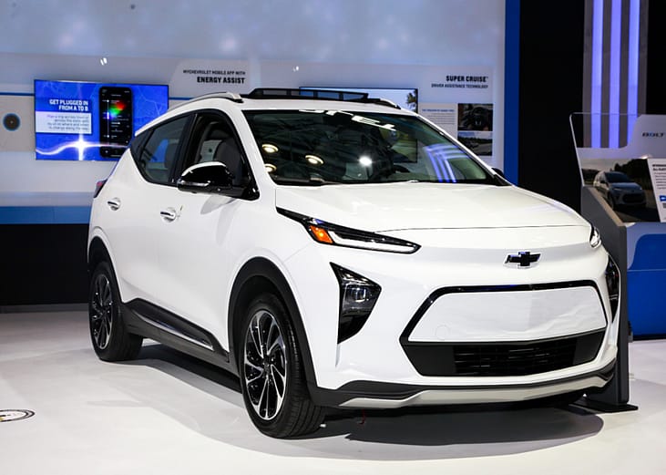 A white Chevrolet Bolt EUV on display in a showroom.