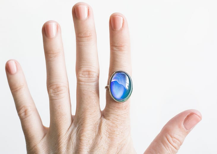 Vintage mood ring on index finger.