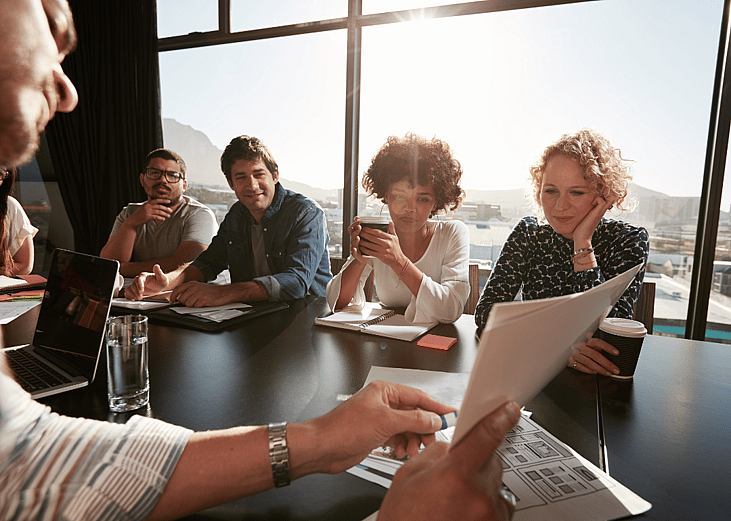 A group of corporate professionals in a conference room.