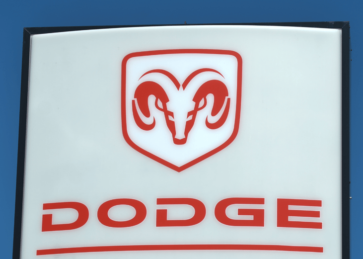 Dodge logo on a sign at a car dealership.