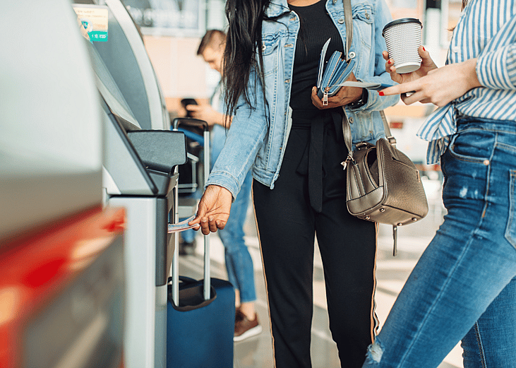 Tourists taking cash out of an airport ATM
