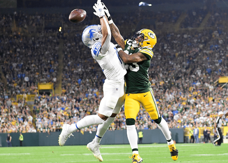 Jaire Alexander #23 of the Green Bay Packers breaks-up a pass against Amon-Ra St. Brown #14 of the Detroit Lions during the first half at Lambeau Field on September 20, 2021 in Green Bay, Wisconsin. 