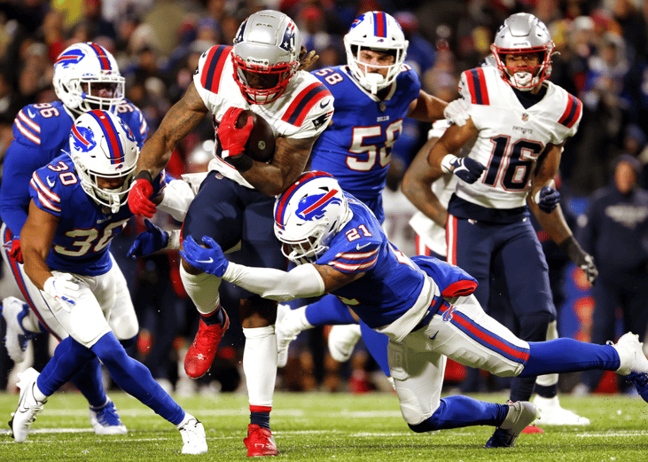 Jordan Poyer #21 of the Buffalo Bills attempts to tackle Brandon Bolden #25 of the New England Patriots during the game at Highmark Stadium on December 06, 2021 in Orchard Park, New York. 