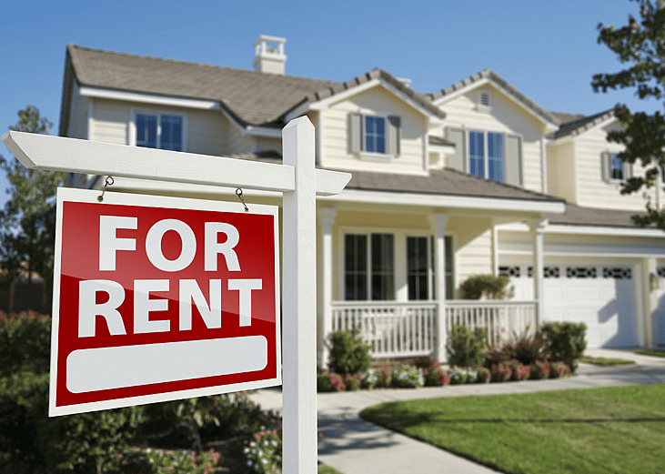 A home with a for rent sign in front