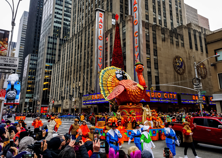 The annual Macy's Thanksgiving Day parade along Avenue of Americas with many balloons floating in the air. Manhattan, New York, USA - November 27, 2014.