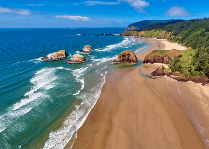 Aerial panorama shot at approximately 350 feet above Cannon Beach looking towards Ecola State Park on a sunny blue sky day on the Oregon Coast
