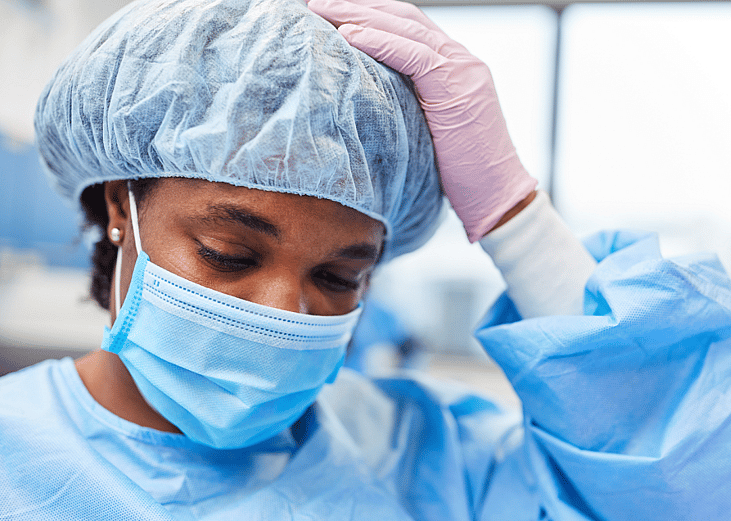 Closeup of an exhausted operating room nurse.