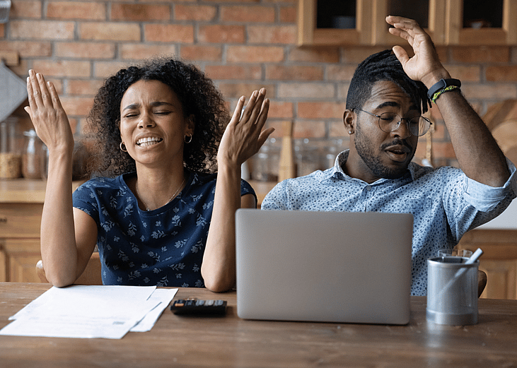 A young Black couple is expressing frustration over financial documents