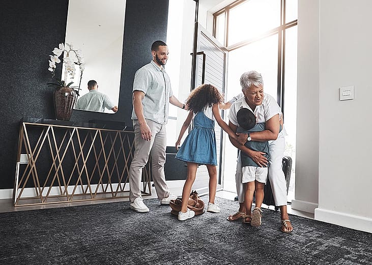 grandparent visiting children and grandchildren in nice home