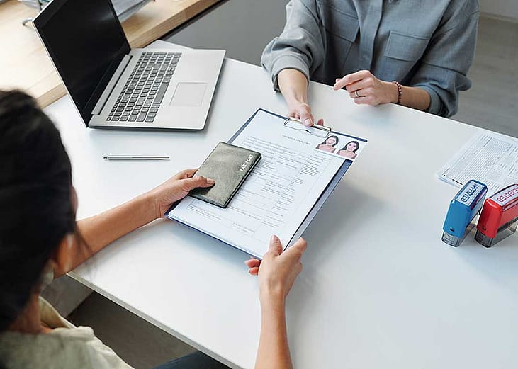 person submitting legal documents across desk