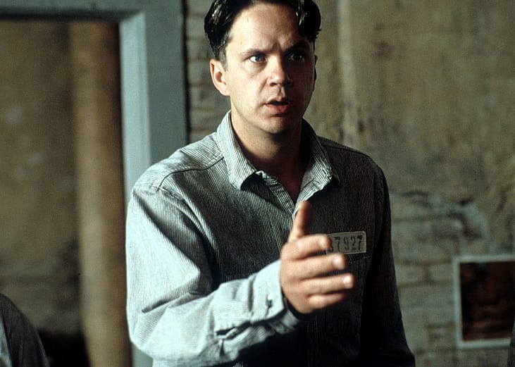 Actor Tim Robbins extends his hand in a scene from the 1994 film 'The Shawshank Redemption.'