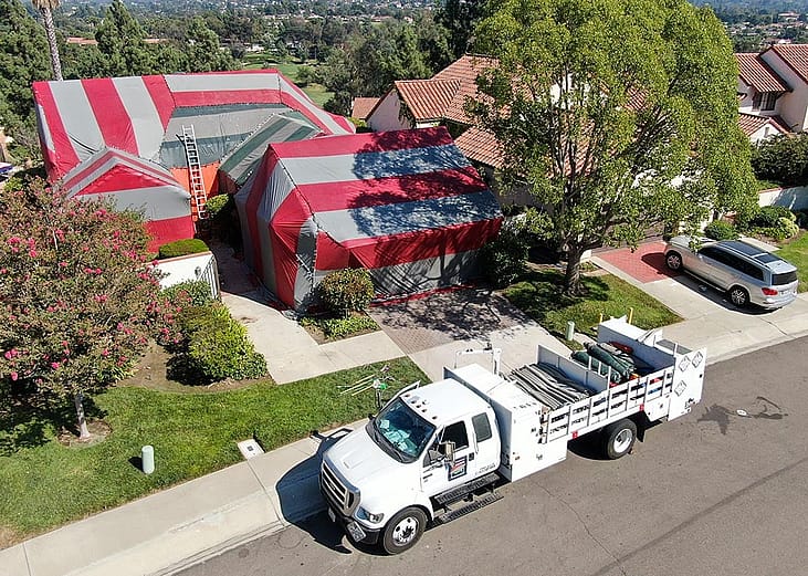 red and green tent covering home being fumigated