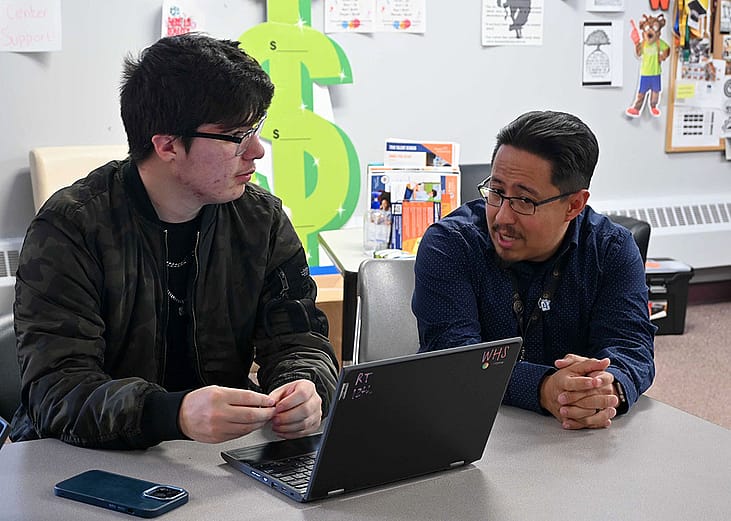 Rene Torres, left, works on his FAFSA with Denver Scholarship Foundation college adviser Federico Rangel at Denver's West High School in April.
