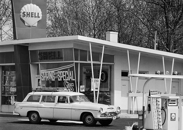 A car sits in front of a Shell gas station in 1958.