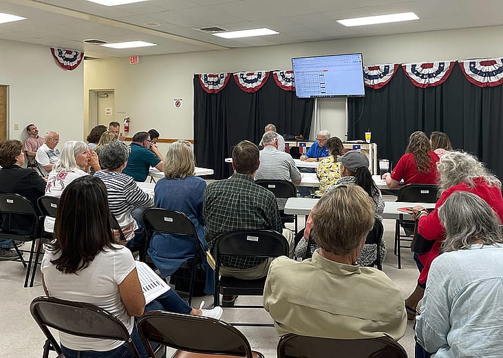 County judges and election workers gather in a full room for the Republican canvass of the primary election.