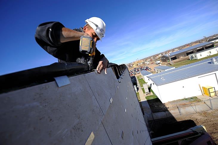 Construction workers building an eco-friendly school
