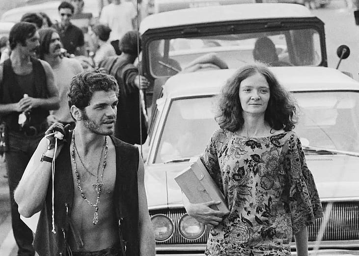 Fans waiting outside their car on the way to the Woodstock Music Festival