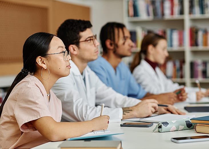 A group of medical students listening during a lecture.