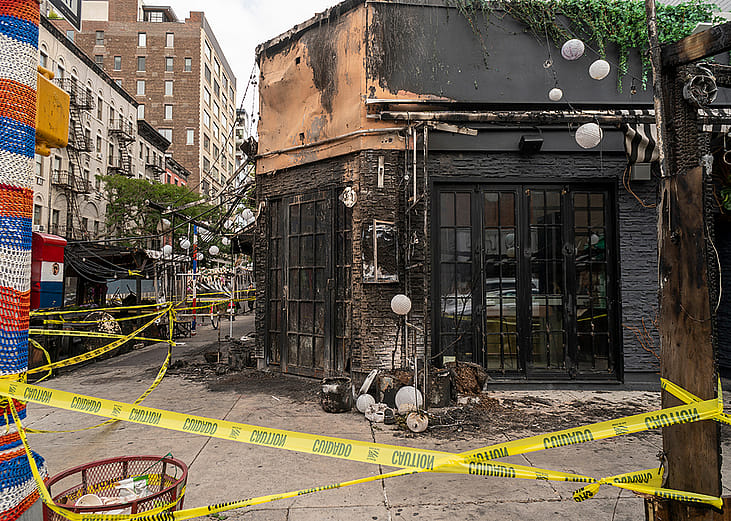 The remains of the outdoor dining and facade of a restaurant after a fire in Chelsea, New York.