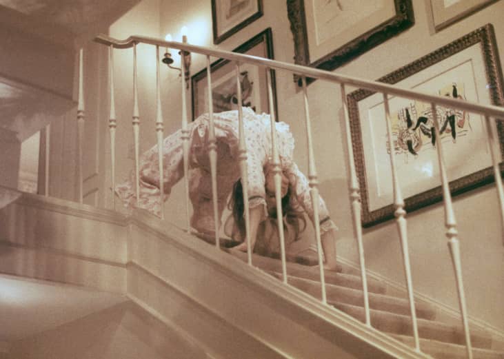 Linda Blair climbs down the staircase backwards on her hands in a scene from 'The Exorcist.'