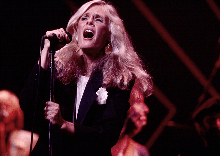 American singer Kim Carnes performs, with her band, onstage at the Savoy, New York, New York, August 25, 1981.
