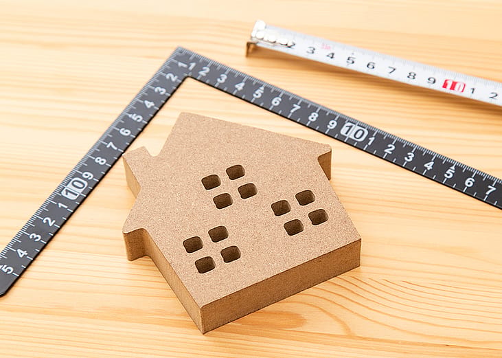 A house figure inside a square measurement tool.