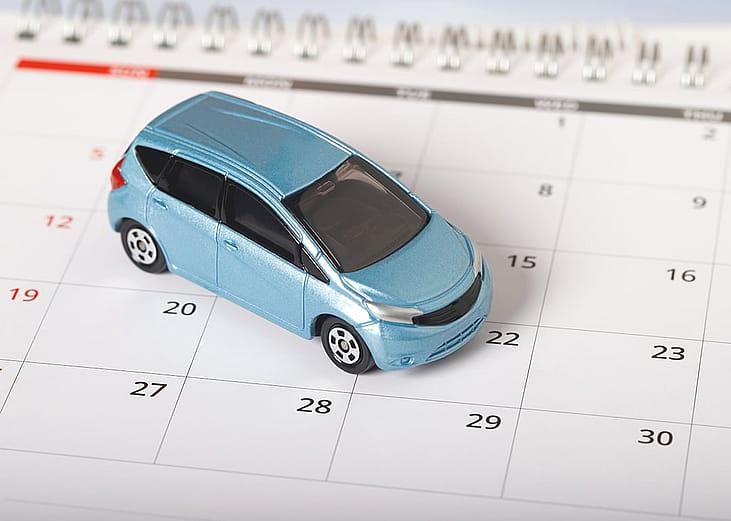A car figure on top of a calendar.
