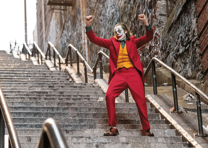 Joaquin Phoenix dancing down a staircase in a scene from 'Joker' (2019)