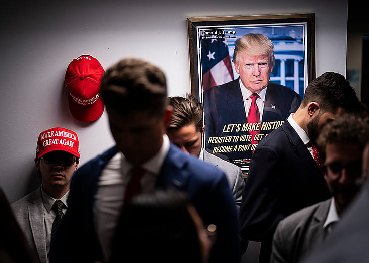 Staff gathering around in a Trump campaign headquarters.