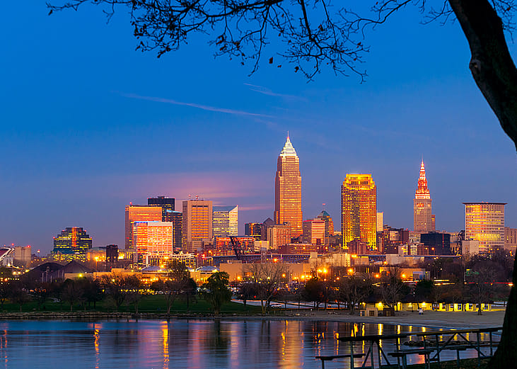 City downtown view of Cleveland, Ohio as it lights up during sunset.