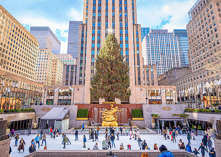 Ice skaters in front of the Christmas tree at the Rockefeller center. 