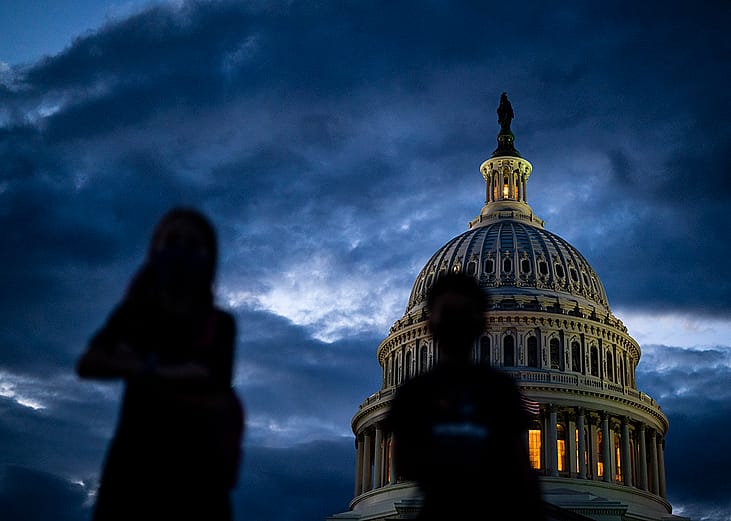 Silhouette of children in front of the Capitol Dome during sunset on Capitol Hill in Washington, DC.
