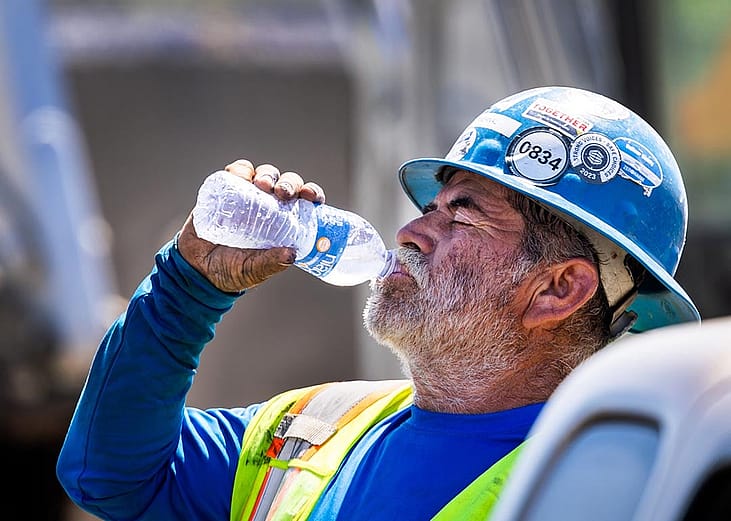 A construction worker takes a water break during a heat wave in California. 
