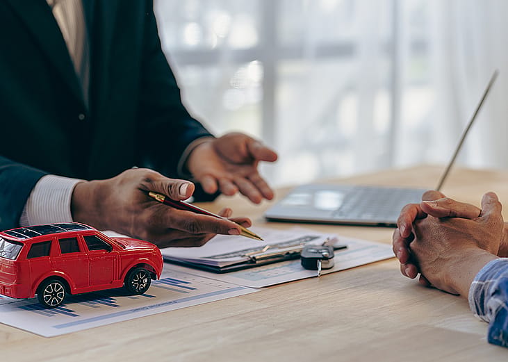 A car insurance transaction between a salesman and customer.