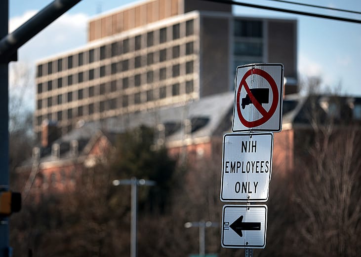 A sign that reads "NIH Employees Only" near an entrance at the National Institute of Health in Bethesda, Maryland.