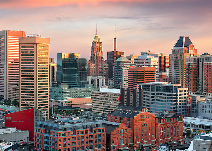 A view of the skyline during dawn over the Inner Harbor in Baltimore, Maryland.