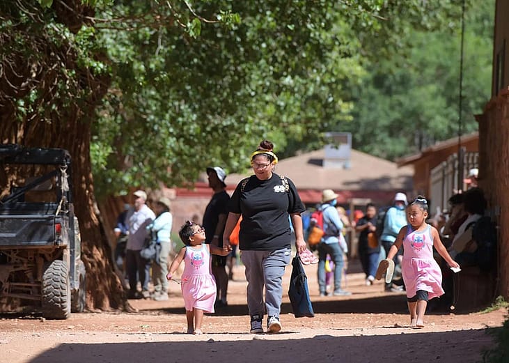 Winona Hastings and her daughters walk through the village of Supai on their way to the Havasupai Head Start and Early Start Program. 