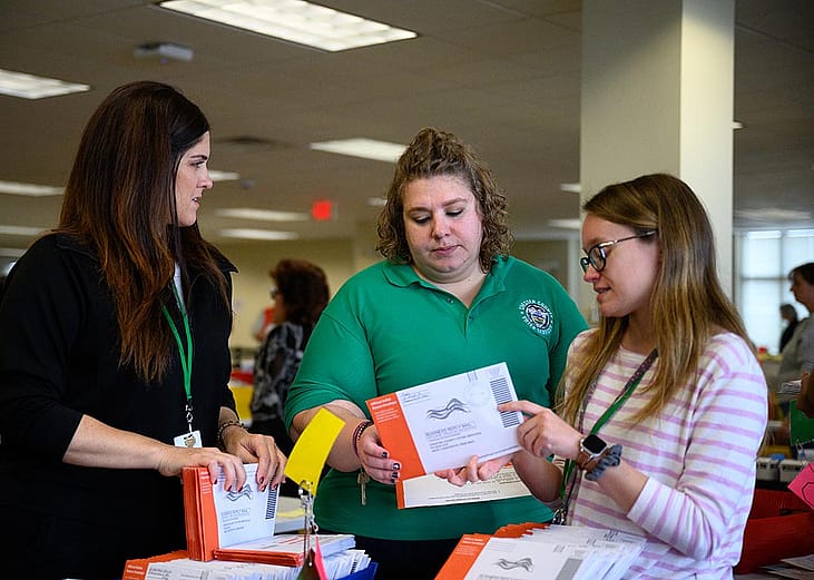 Election workers review a mail-in ballot with an incorrect signature at Chester County's central scanning location in West Chester, Pennsylvania.